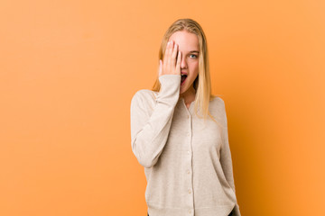 Cute and natural teenager woman having fun covering half of face with palm.