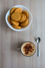Cappuccino and cookies on a wooden table