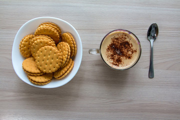 Cappuccino and cookies on a wooden table