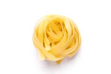 Uncooked fettuccine pasta ball isolated over the white background