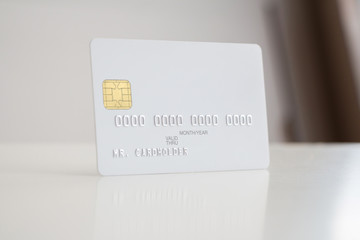 White blank bank card on soft blurred background