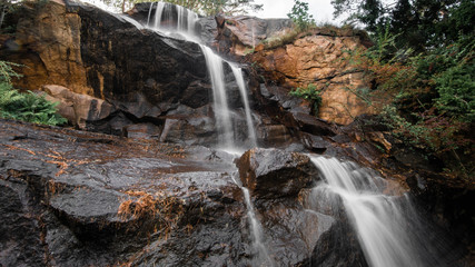 Fototapeta na wymiar Long Exposure photo of a waterfall. Daytime in the autumn,