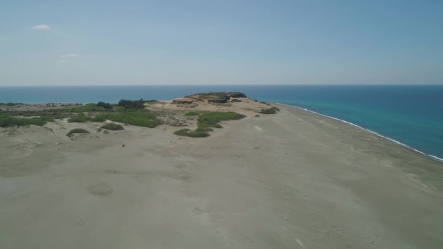 Aerial view of beautiful lonely beach and Paoay sand dune. Philippines, Luzon. Sand dunes near to the sea with sky. Ilocos Norte.