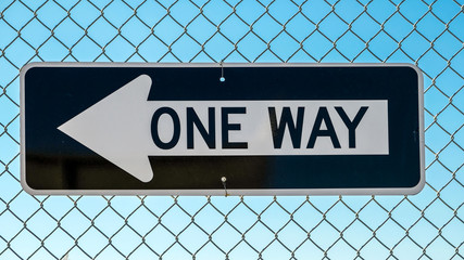 One way sign on wire fence