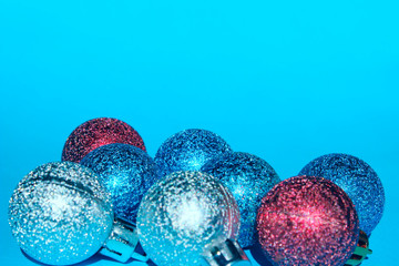 Christmas decoration over blue background. Holidays, Christmas toys concept. Blue, red and silver Christmas balls over blue background.