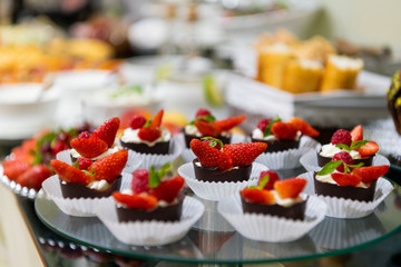 A tasty sweet dessert with creme and strawberries on a breakfast buffet at a hotel.