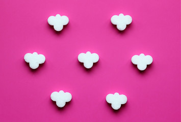 decorative sugar figures in the form of clouds on a pink background