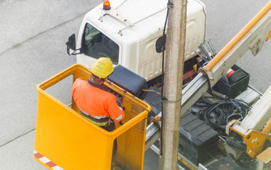 Electrician working in the mobile crane basket.