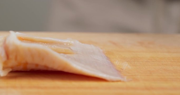 Cutting Fresh Geoduck on wooden board