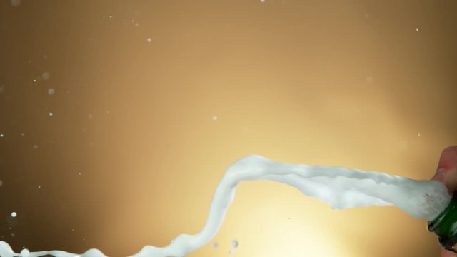 Super slow motion of Champagne explosion, opening champagne bottle closeup. Filmed on high speed cinema camera, 1000fps