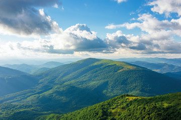 summer afternoon in mountains. wonderful landscape of green carpathian. beautiful fluffy clouds on a blue sky above the ridge. travel freedom concept.
