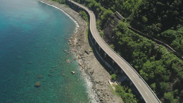 Aerial view of Patapat viaduct in the coast of Pagudpud, Ilocos Norte. Highway with bridge by coast sea near the mountains. Philippines, Luzon.