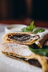 delicious and juicy Russian pancakes with stuffing and sauces served for serving at the restaurant for breakfast