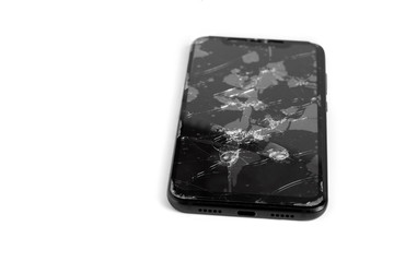 Broken screen cell phone on white isolated background.