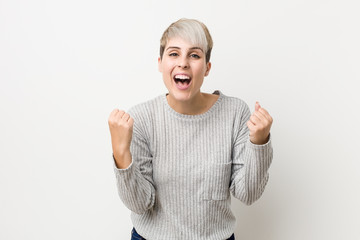 Young curvy caucasian woman isolated on white background cheering carefree and excited. Victory concept.