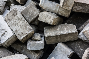 random gray brick heap, modern industry diversity. Close up pavement stones as background