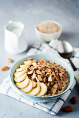 Barley porridge with banana slices and almonds