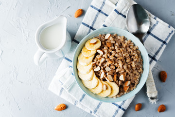 Barley porridge with banana slices and almonds
