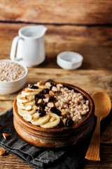 Barley porridge with banana slices and almonds