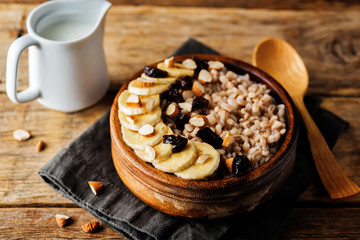 Barley porridge with banana slices and almonds