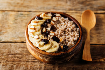 Barley porridge with banana slices and almonds