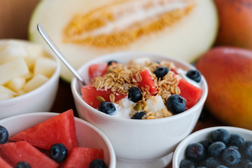 bowl with cereal, fruits and yogurt - healthy breakfast