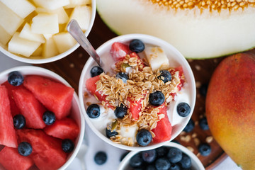 bowl with cereal, fruits and yogurt - healthy breakfast
