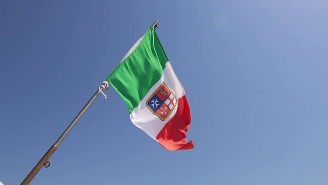 Italian merchant flag on a boat maritime waving in wind Sardinia Sardegna Italy