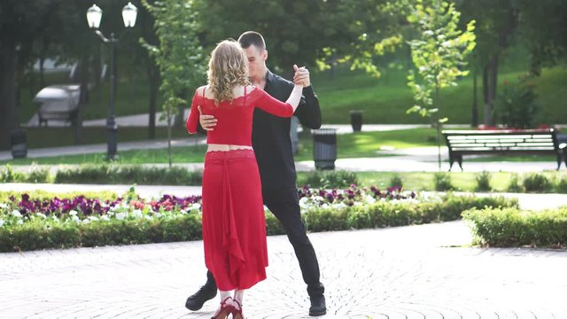 Beautiful couple dancing the street rumba