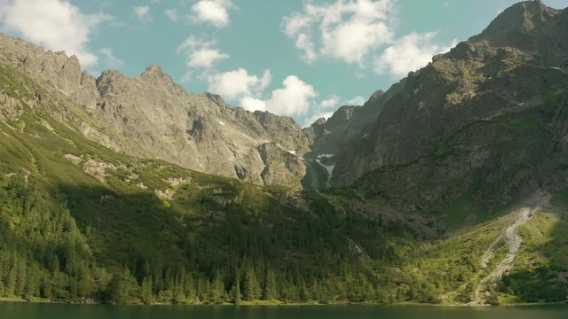 Flight of a drone over beautiful azure lakes in the alpine mountains. Tatra National Park in Poland.  Morskie oko lake.