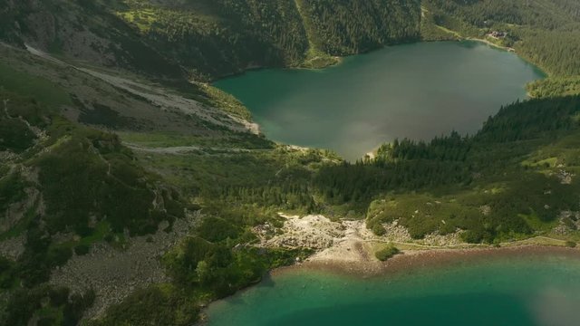 Flight of a drone over beautiful azure lakes in the alpine mountains. Tatra National Park in Poland.  Morskie oko lake.