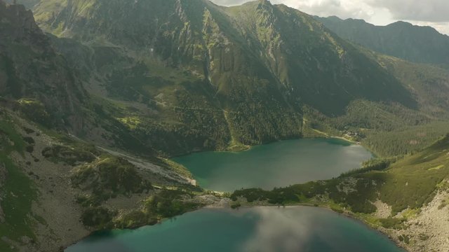 Flight of a drone over beautiful azure lakes in the alpine mountains. Tatra National Park in Poland.  Morskie oko lake.