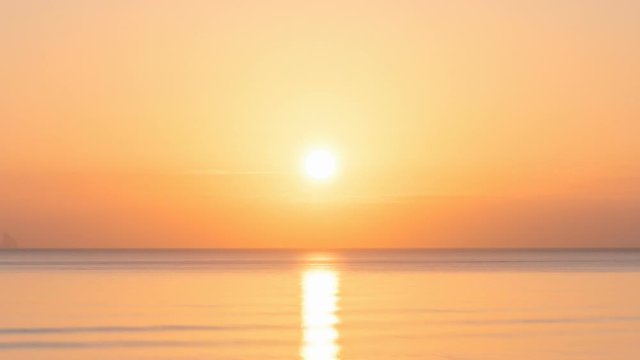 Golden sunset over the sea in summer time lapse
