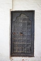 Black old metal door with iron key lock