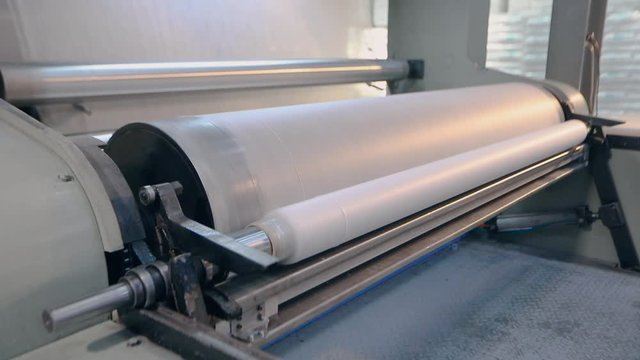 Rolls of non-woven fabric are being pushed into the tube. Nonwoven fabric production