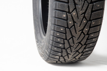 Winter car tires with spikes. Car tires on white background. Shop tires and wheels.