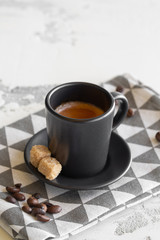 Obraz na płótnie Canvas A cup of fragrant espresso in a beautiful clay cup. Two pieces of cane sugar.