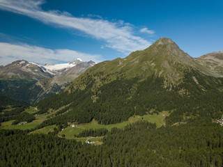 church/chapel close to cliff drop-off above mountain valley