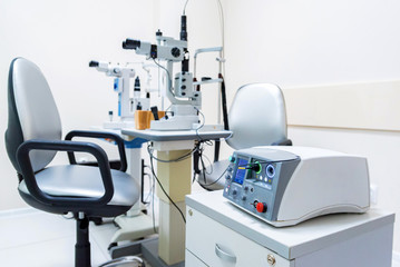 Close up modern ophthalmological laser used for eye surgery on table - obrazy, fototapety, plakaty