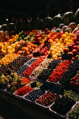 Vegetables and fruits on shelves in the market.