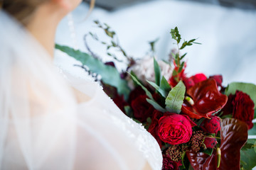 Beautiful wedding bouquet of flowers in the hands of the newlyweds