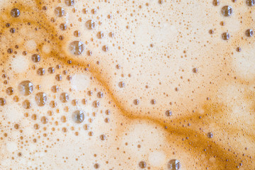 Black coffee with milk cream foam texture.