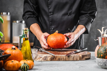 Chef cutting fresh and delicious pumkin and vegetables for cooking soup - obrazy, fototapety, plakaty