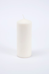Fototapeta na wymiar White candle on the white isolated background