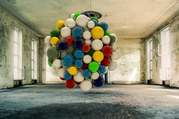 colored spheres intallation inside an empty room