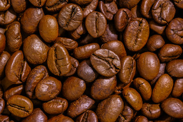 Preparing roasted coffee beans up. Photo filtered in vintage style can be used as a background 