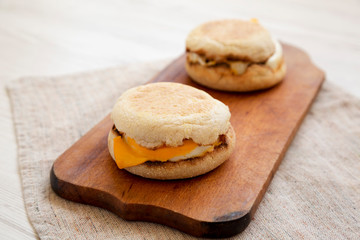 Homemade egg sandwich with cheese on a rustic wooden board, low angle view. Closeup.