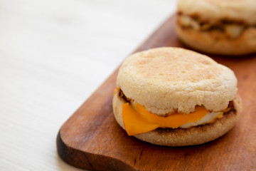 Homemade egg sandwich with cheese on a rustic wooden board, low angle view. Copy space.