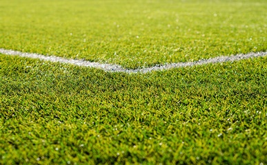 Corner of football field  White markings on green grass