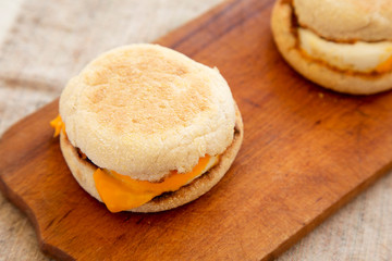 Homemade egg sandwich with cheese on a rustic wooden board, low angle view. Close-up.